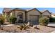 Attractive desert landscape surrounds this charming two-story home with a two-car garage at 1577 E Laurel Dr, Casa Grande, AZ 85122