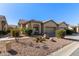 Attractive desert landscape surrounds this charming two-story home with a two-car garage at 1577 E Laurel Dr, Casa Grande, AZ 85122