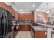 Modern kitchen features dark wood cabinets, granite counters, and black appliances at 1577 E Laurel Dr, Casa Grande, AZ 85122