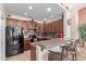 Modern kitchen with dark wood cabinets, granite countertops, and stainless steel appliances at 1577 E Laurel Dr, Casa Grande, AZ 85122