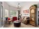 Cozy living room boasts a brown leather couch, ottoman, and grandfather clock at 1577 E Laurel Dr, Casa Grande, AZ 85122