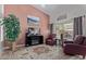 Comfortable living room with two red leather armchairs and a large TV at 1577 E Laurel Dr, Casa Grande, AZ 85122