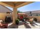 Relaxing patio area with seating, a grill, and a covered swing at 1577 E Laurel Dr, Casa Grande, AZ 85122