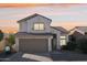 Two-story house with tan exterior and a two-car garage at 15857 W Yavapai St, Goodyear, AZ 85338