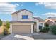 Two-story house with tan exterior and a two-car garage at 15857 W Yavapai St, Goodyear, AZ 85338