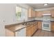 Bright kitchen with ample cabinetry, stainless steel sink, and white appliances at 15857 W Yavapai St, Goodyear, AZ 85338