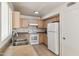 Well-equipped kitchen featuring wood cabinets and white appliances at 15857 W Yavapai St, Goodyear, AZ 85338