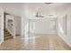 Open living room featuring tile floors and a ceiling fan at 15857 W Yavapai St, Goodyear, AZ 85338