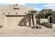 Tan stucco house with a two-car garage and gated entry at 16615 N 30Th Ave, Phoenix, AZ 85053