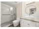 Modern bathroom with glass shower door, square sink, round mirror, and neutral color palette at 1701 E Colter St # 223, Phoenix, AZ 85016