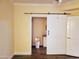 Bathroom with a barn door and white toilet at 1701 E Colter St # 223, Phoenix, AZ 85016