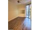 Bright bedroom with wood-look floors, large mirror, and access to balcony at 1701 E Colter St # 223, Phoenix, AZ 85016