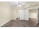 Bright bedroom with vinyl flooring, closet, ceiling fan, and barn-style door to bathroom at 1701 E Colter St # 223, Phoenix, AZ 85016