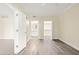 Spacious bedroom with neutral walls, white trim, and hardwood-style floors leading to bathroom and closet at 1701 E Colter St # 223, Phoenix, AZ 85016