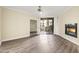 Bright living room with a fireplace, ceiling fan, wood floors, and access to the balcony at 1701 E Colter St # 223, Phoenix, AZ 85016