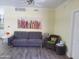 Living room with gray sofa and a colorful piece of art at 1701 E Colter St # 223, Phoenix, AZ 85016