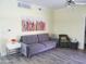 Living room with gray sofa and a colorful piece of art at 1701 E Colter St # 223, Phoenix, AZ 85016