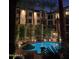 Night view of the community pool and palm trees at 1701 E Colter St # 223, Phoenix, AZ 85016