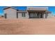 Back view of a modern home with a covered patio and picture windows at 17017 W Baker Dr, Surprise, AZ 85387