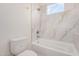 Cozy bathroom with white marble tile features a tub and shower combination at 17017 W Baker Dr, Surprise, AZ 85387