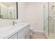 Modern bathroom featuring marble-style wall tiles, glass shower and vanity at 17017 W Baker Dr, Surprise, AZ 85387