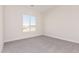 Bright bedroom with a view from the window and soft gray carpet at 17017 W Baker Dr, Surprise, AZ 85387