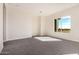 Bedroom with plush neutral carpet, recessed lighting, and a large picture window with desert views at 17017 W Baker Dr, Surprise, AZ 85387