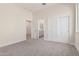 This bedroom has neutral carpet and an entrance to the bathroom and walk-in closet at 17017 W Baker Dr, Surprise, AZ 85387