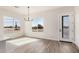 Bright dining area featuring large windows and modern chandelier at 17017 W Baker Dr, Surprise, AZ 85387