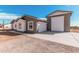 Charming single-story home featuring an attached garage and long driveway at 17017 W Baker Dr, Surprise, AZ 85387