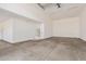 Spacious, unfinished garage with a sealed concrete floor and white walls at 17017 W Baker Dr, Surprise, AZ 85387