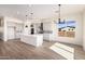 Spacious kitchen featuring a center island, pendant lighting, and stainless steel appliances at 17017 W Baker Dr, Surprise, AZ 85387