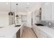 Modern kitchen with center island, stainless steel appliances, and decorative backsplash at 17017 W Baker Dr, Surprise, AZ 85387