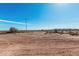 Expansive land view showcasing the beautiful blue skies, sparse vegetation, and utility poles at 17017 W Baker Dr, Surprise, AZ 85387