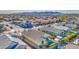 Aerial view of a house with a pool, mountain views, and a community at 18216 W Foothill Dr, Surprise, AZ 85387