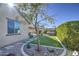 Landscaped backyard with artificial turf and stone pathway at 18216 W Foothill Dr, Surprise, AZ 85387