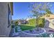 Landscaped backyard with artificial turf and stone pathway at 18216 W Foothill Dr, Surprise, AZ 85387