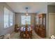 Bright dining room with wood table, hutch, and large windows at 18216 W Foothill Dr, Surprise, AZ 85387