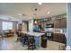 Modern kitchen with granite countertops, dark cabinetry, and an island at 18216 W Foothill Dr, Surprise, AZ 85387