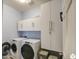 Laundry room with washer, dryer, and ample cabinet storage at 18216 W Foothill Dr, Surprise, AZ 85387