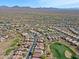 Aerial showing neighborhood near golf course and mountains at 1828 W Owens Way, Anthem, AZ 85086