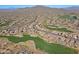 Aerial view of community near golf course and mountains at 1828 W Owens Way, Anthem, AZ 85086