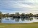 Scenic community lake with a playground and walking paths at 1828 W Owens Way, Anthem, AZ 85086