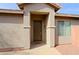 Front entry with a brown door and a welcome mat at 1828 W Owens Way, Anthem, AZ 85086