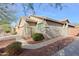 Tan stucco house with a landscaped front yard and walkway at 1828 W Owens Way, Anthem, AZ 85086