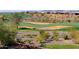 Scenic view of a golf course with sand traps and residential homes at 1828 W Owens Way, Anthem, AZ 85086