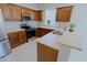 Kitchen with wood cabinets, stainless steel appliances, and an island at 1828 W Owens Way, Anthem, AZ 85086