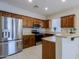 Kitchen with wood cabinets, stainless steel appliances, and an island at 1828 W Owens Way, Anthem, AZ 85086