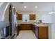 Kitchen with stainless steel appliances and wood cabinets at 1828 W Owens Way, Anthem, AZ 85086