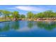 Serene community lake with waterfall feature and lush landscaping at 1828 W Owens Way, Anthem, AZ 85086